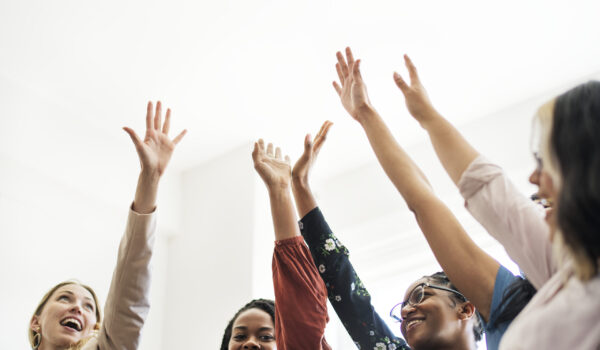 Businesswomen putting hands in the middle